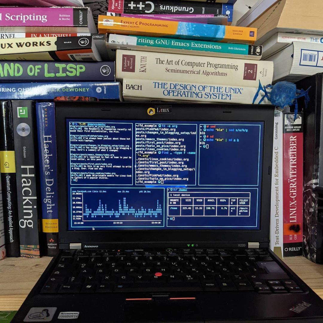 Laptop with code in front of many books