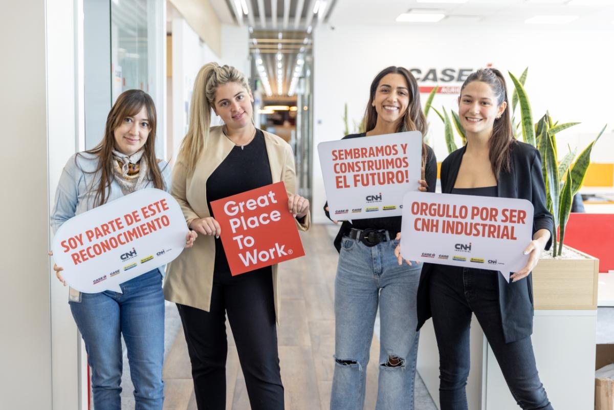 4 people holding signs celebrating Great Place to Work certification