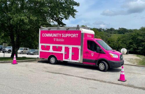 Pink TMobile "community support" van in a parking lot
