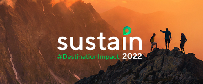 Sustain #DestinationImpact 2022. Three climbers on a mountain top at sunset.