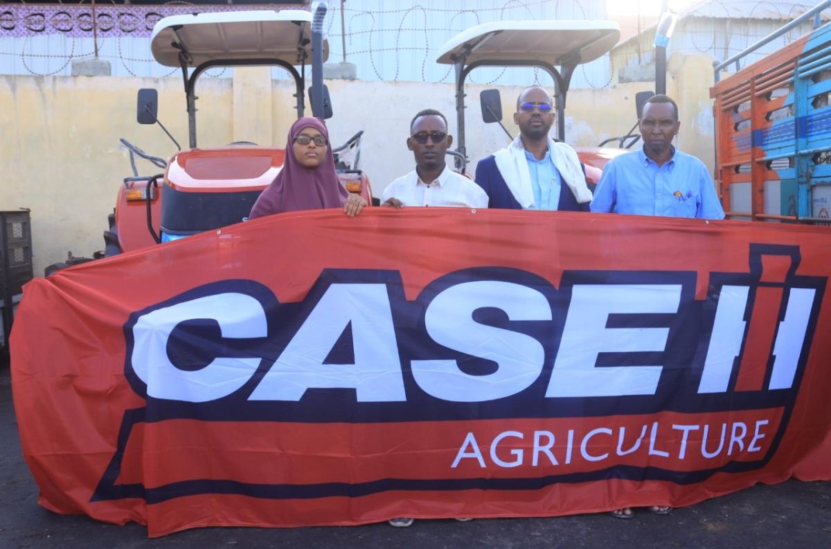 Gaalooge Team Members holding a banner that reads, "CASE IH"