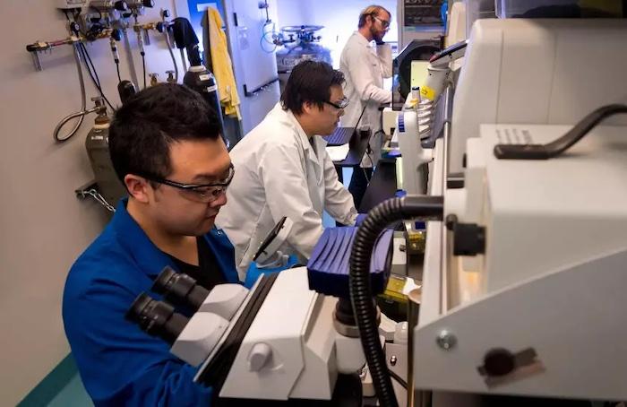 UC San Diego graduate students Yoon Lee, Nathan Chang, and Evan Tjeerdema work in the new Illumina Laboratory in Hubbs Hall on the Scripps Institution of Oceanography campus.(Courtesy of Erik Jepsen/UC San Diego)