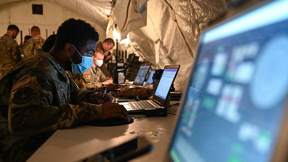 Military personnel using laptops