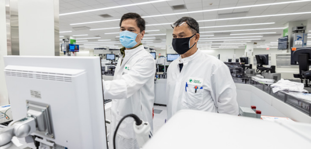 Two people in lab coats in a lab