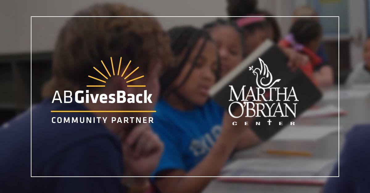 Logos for AB Gives Back and Martha O'Bryan Center over kids reading
