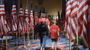children walking through rows of American flags