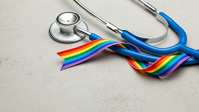 Physician's stethoscope with rainbow ribbon.