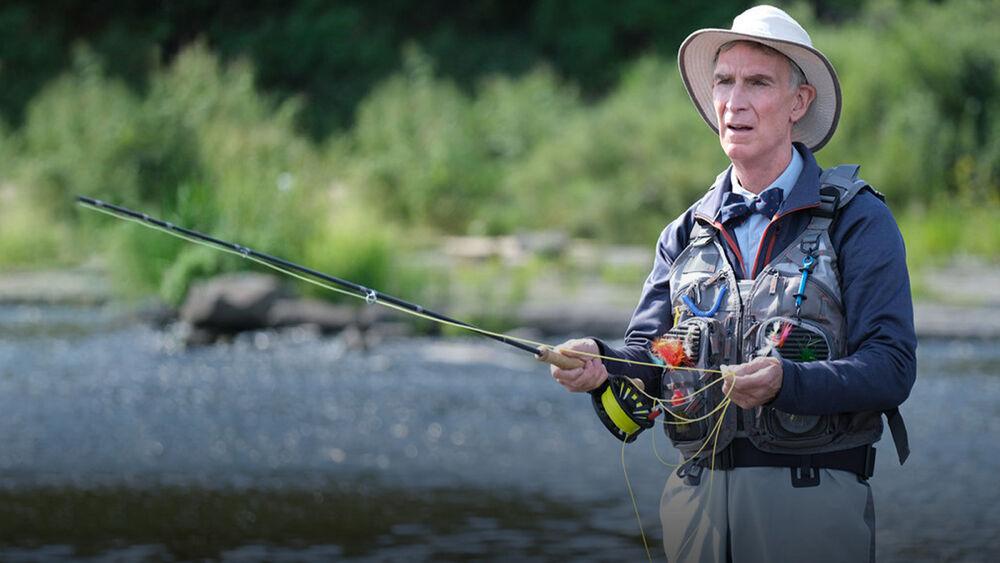Bill Nye in a river fly fishing