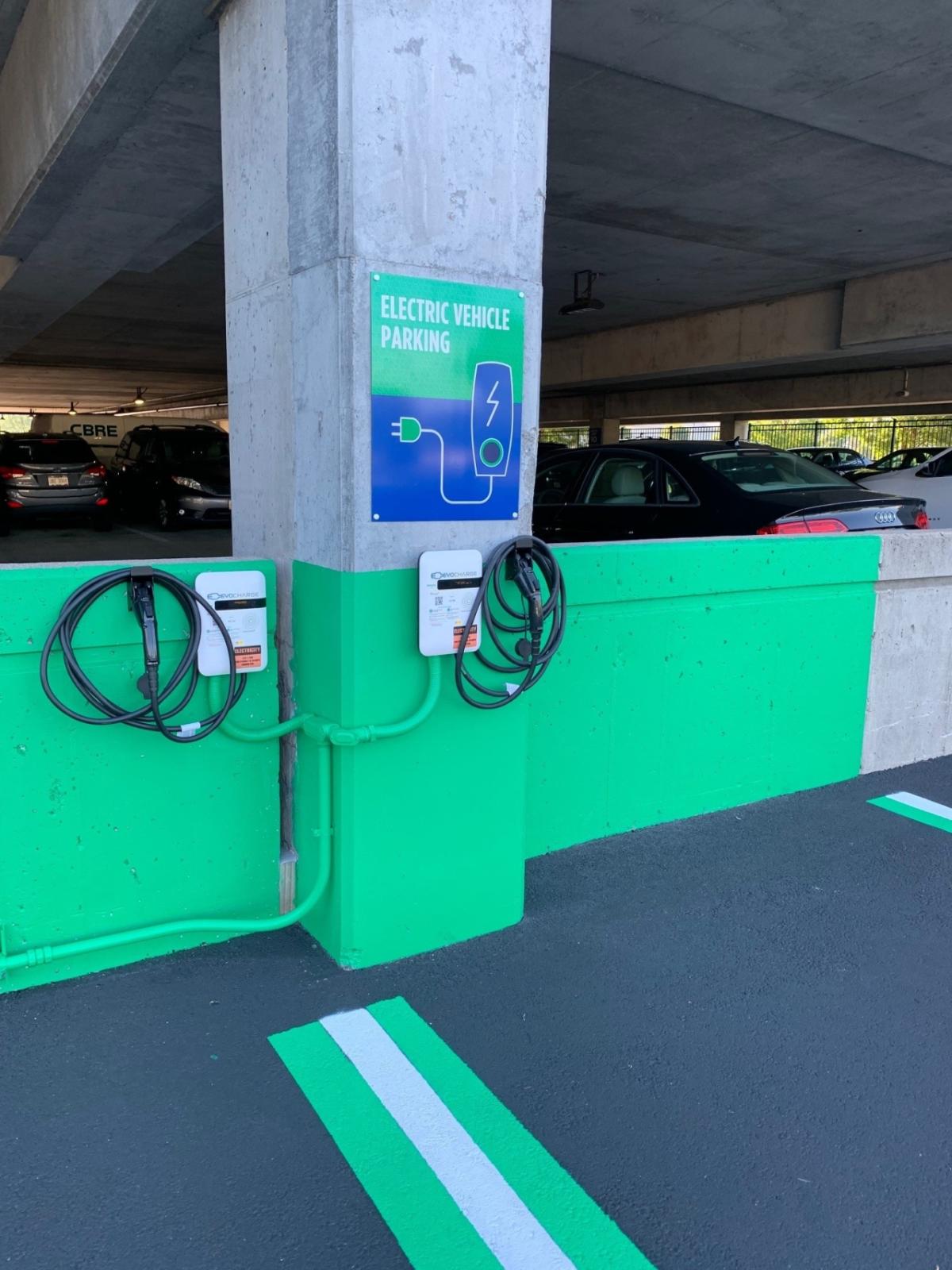 Electric vehicle charging station in a parking garage