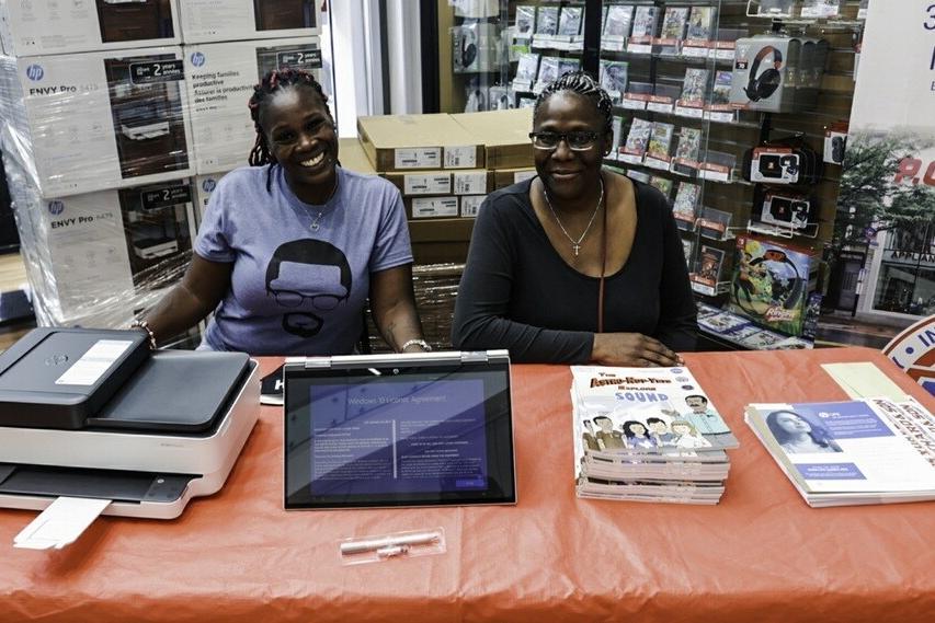 Tanesha Grant (left), founder of the digital equity nonprofit Parents Supporting Parents NYC, and PSPNY Senior Advisor Elzora Cleveland at a recent technology giveaway event at the PC Richard & Son Harlem Superstore in New York.