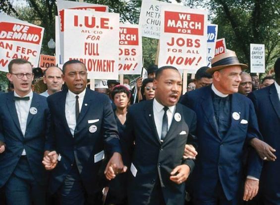 Dr. Martin Luther King and civil rights leaders marching.