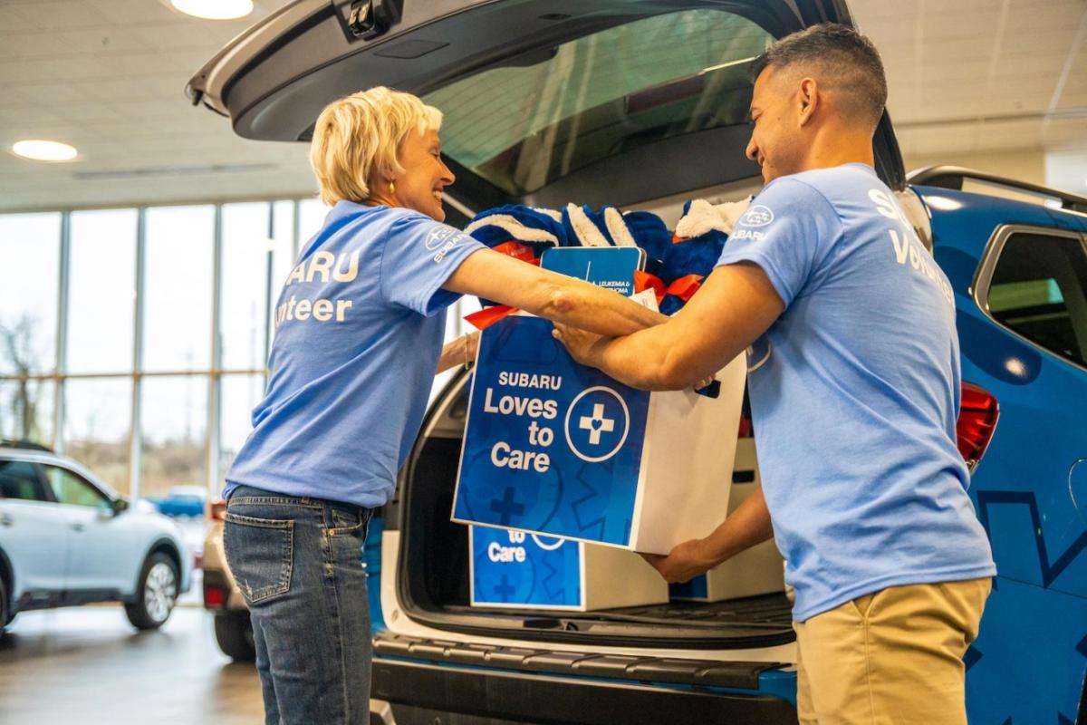 Subaru employees loading supplies into car