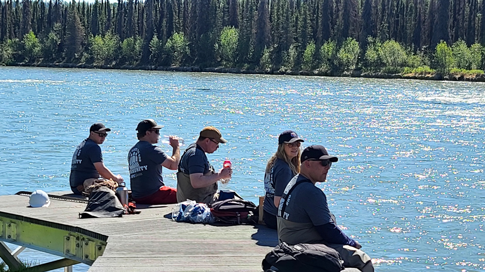 volunteers eating lunch on the dock