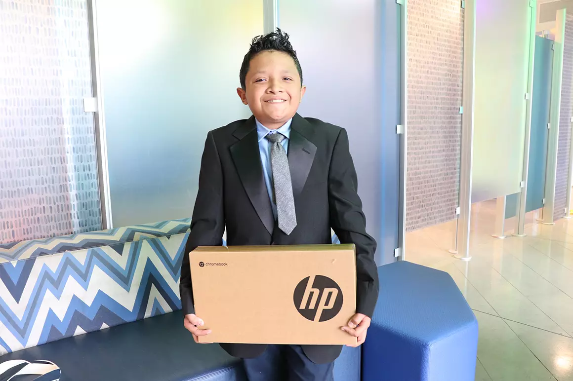 Student holding a HP box