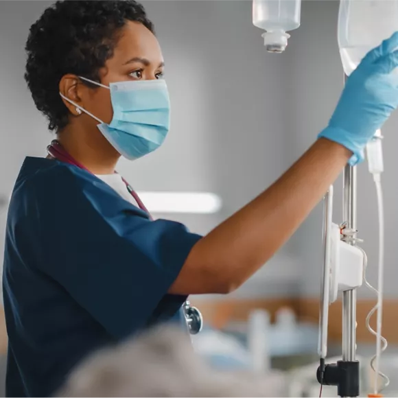 Nurse hanging an IV bag
