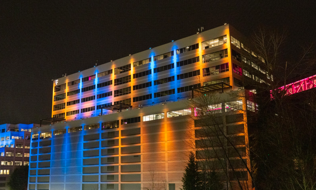 T-Mobile Headquarters in Bellevue, WA lit up in yellow and blue lights