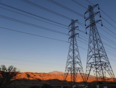 two electricity towers in a desert landscape