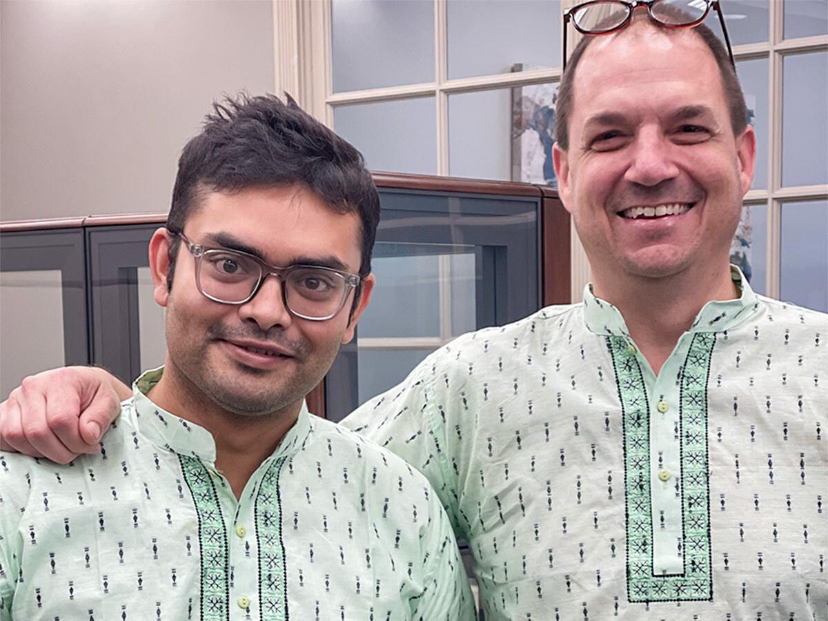 Two employees wearing traditional clothing from Bangladesh